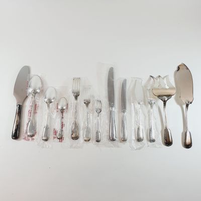 a lot of silverware on a table with a spoon and knife