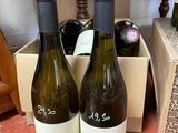 three bottles of wine are sitting in a box on a table