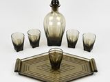 four glasses and a decanter sitting on a tray