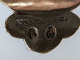 a silver spoon that has a face on it