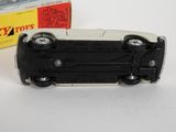 a black and white toy car next to a boxed box