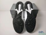 the soles of a pair of black and white sneakers