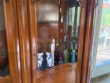 a wooden cabinet with a glass door in a room