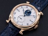 a close up of a watch on a black surface with a blue strap