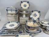 a lot of blue and white plates and bowls on the table