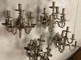 a wall with a bunch of chandeliers hanging on it