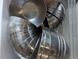 a lot of metal bowls and pans in a white box