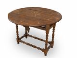 an old wooden table with a leaf design on the top of it