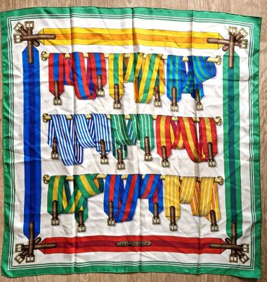 a colorful scarf hanging on a clothes line on a wooden floor