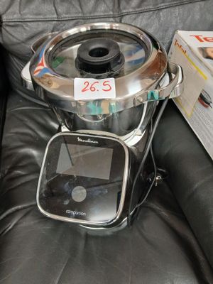 a black leather chair with a metal pot on top of it