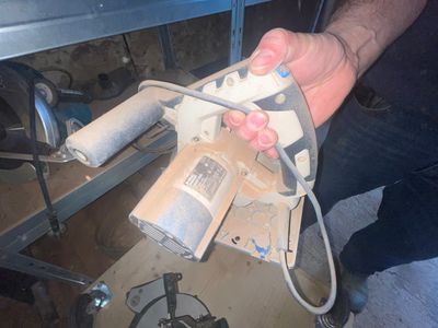 a man that is holding a tool in his hand