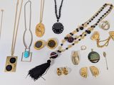 an assortment of jewelry including a necklace, earrings, and brooches