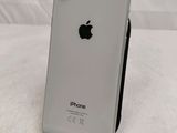 an apple iphone sitting on top of a stand on a bed