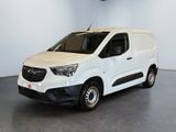 the white van is parked in a large room with a ceiling fan