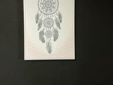 a picture of a drawing of a dream catcher on the wall