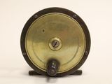 a small metal object on a stand on a white surface