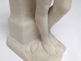 marble statue of a boy holding a bird on a pedestal