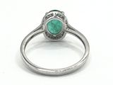 an image of a close up of a ring with a green stone