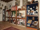 a room with a lot of shelves and pictures on the wall