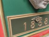 a statue of a man ' s head on a plaque