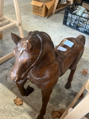 a statue of a horse that is standing in a room