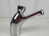 a silver faucet with a red handle on a white table