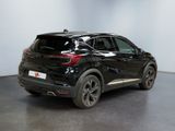 the rear end of a black suv parked in a showroom