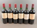 six bottles of wine lined up in a row on a table