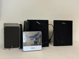 three speakers and a speaker box sitting on a table