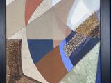 painting of abstract shapes in a black frame on a wall