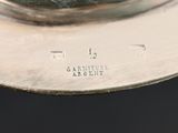 a close up of a silver plate on a table