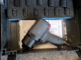 a drill in a tool box with tools inside of it