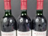 three bottles of wine sitting on top of a table next to each other