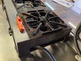 stainless steel counter top in a commercial kitchen with a burner on it