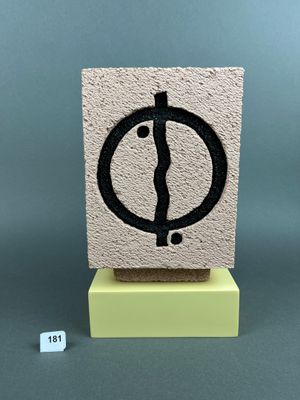 an image of a stone block with a black and white symbol on it