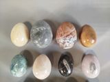 seven different types of marbles on a white surface