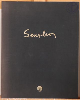 a black book sitting on top of a wooden shelf next to a plant