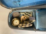 a blue case with a gun and other items inside of it