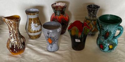a lot of vases that are sitting on a table