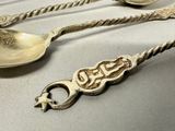 three spoons and two spoon spoons on a table