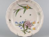 an image of a plate with a bird and flowers on it