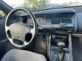 the interior of a car with a steering wheel, dashboard, and dashboard controls