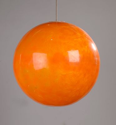 an orange glass ball hanging from a metal rod