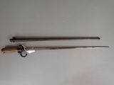 pair of old metal tools on a white surface