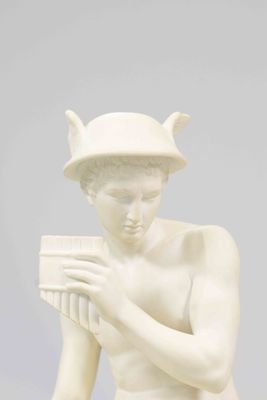 statue of a man with a flute in his hands