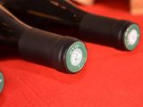 three bottles of wine sitting on a red table