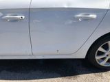 a white car that is parked in the parking lot