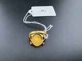 an image of a gold coin with a tag attached to it