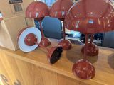 many red lamps on a wooden table in a store
