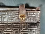 an image of a brown purse with a gold buckle